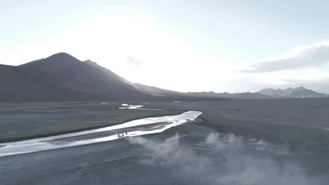 Dramatic Drone Over Dry Ladakh Landscape with River and Galloping Horses in the Stock-Footage 335760954