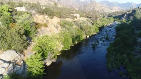 Dramatic Drone rise over western river revealing mountains valley California Stock Footage 232085990