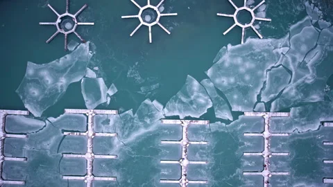 Dramatic drone shot of frozen harbor waters and winter ice on Lake Michigan Stock Footage 331683340