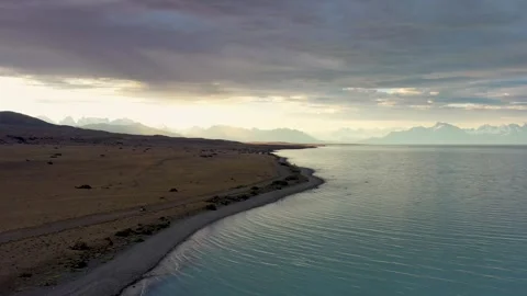 Dramatic drone view of adventurer driving on the shore of Lake Viedma Stock Footage 255838937