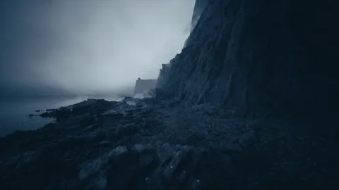 Dramatic dusk scene featuring foggy cliffs and distant headland atmosphere Video stock 331400154