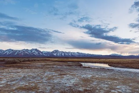 Dramatic Dusk sky against river and Sierra Nevada Mountains Stock Photos