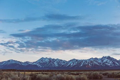 Dramatic Dusk sky over Arid plains against Sierra Nevada Mountains 写真素材