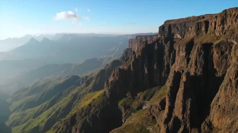 Dramatic early morning light reveals rugged escarpments and serene mountain Stock Footage 323282474