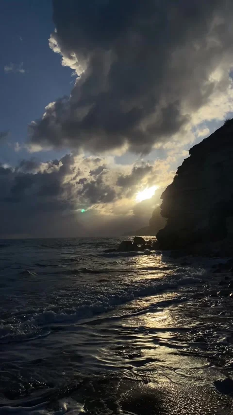 Dramatic early sunset at the beach with rocks Stock Footage 255798002