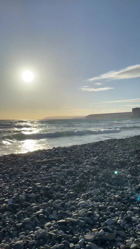 Dramatic early sunset at the beach with rocks Stock Footage 255799203