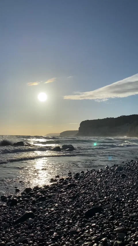 Dramatic early sunset at the beach with rocks Stock Footage 255799296