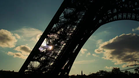 Dramatic Eiffel Tower stair silhouette at sunset, with people, sun rays Stock Footage 313412105