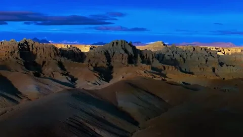 Dramatic Eroded Peaks and Distant Snow Mountains Under Blue Sky Tibet China Stock Footage 346737356