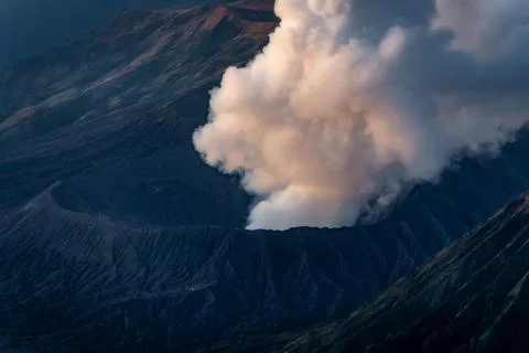 A Dramatic Eruption of a Volcano Creates Billowing Clouds of Smoke and Plum.. 스톡 사진