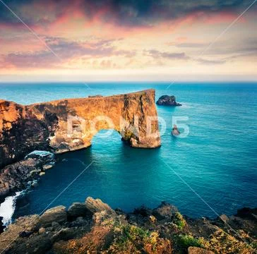 Dramatic evening scene of Dyrholaey arch. Stock Photos