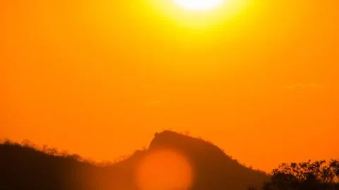 Dramatic evening sky ablaze with vibrant orange and yellow hues, highlighti.. Stock Photos