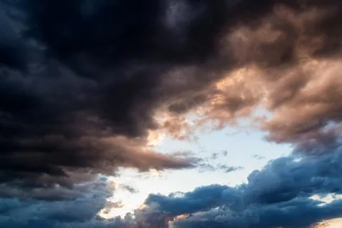 Dramatic evening sky with dark stormy clouds Stock Photos
