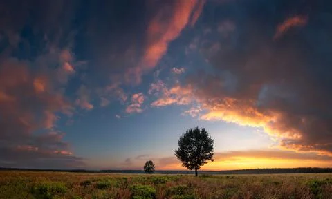Dramatic evening sky over field Stock Photos