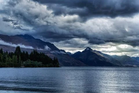 Dramatic evening sky over the mountains and lake Wakatipu in New Zealand Stock Photos