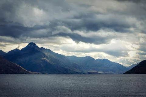 Dramatic evening sky over the mountains and lake Wakatipu in New Zealand Stock Photos