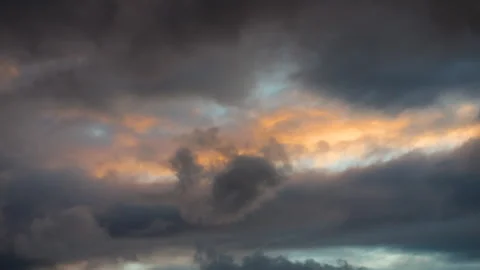 Dramatic evening sky with storm clouds and sunlight breaking through.	 Stock-Footage 319872292