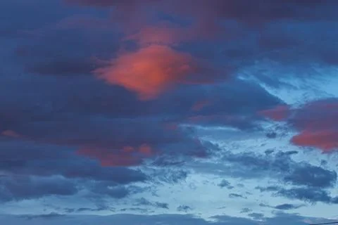 Dramatic evening sky with vibrant clouds in shades of blue and orange, showca Stock Photos