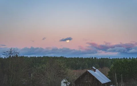 Dramatic Evening sky with yellow moon rising over County scene Stock Photos
