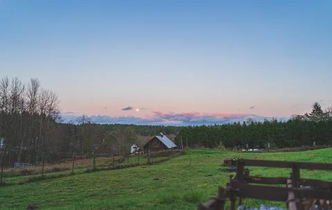 Dramatic Evening sky with yellow moon rising over County scene Stock Photos