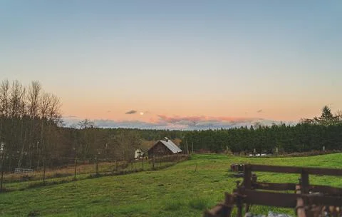 Dramatic Evening sky with yellow moon rising over County farm Stock Photos