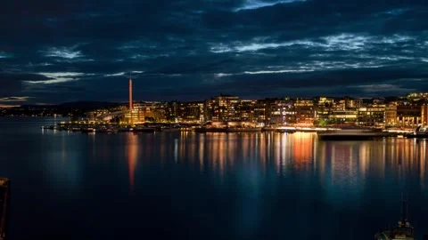 Dramatic evening timelapse of Oslo waterfront with illuminated marina yachts Stock Footage 306389066
