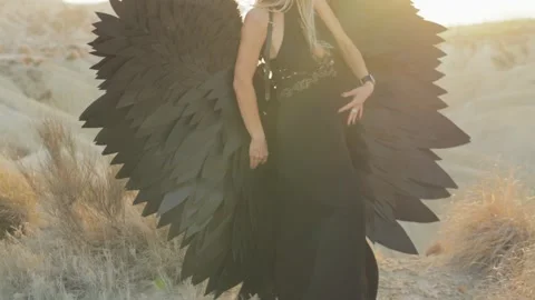 Dramatic fashion model posing with black angel wings, wearing elegant black.. Stock Footage 311671270