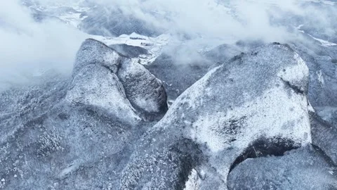 Dramatic Fast-Moving Clouds Over Snow-Covered Mountain Peaks, Aerial View Stock Footage 344248163