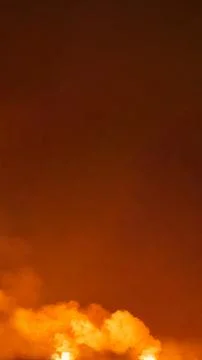 Dramatic fiery red and orange stormy sky with dark clouds and bright smoke,.. Stock Photos