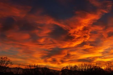 Dramatic fiery sky with bright orange sunset clouds Stock Photos