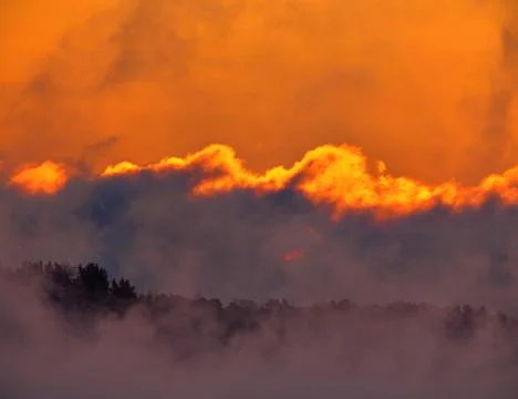 Dramatic fiery sunrise on extremely cold winter morning Stock Photos