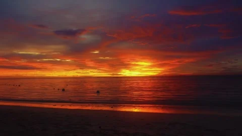 Dramatic Fiery Sunset Over Ocean with Intense Orange Clouds and Water Reflection 스톡 동영상 331834781