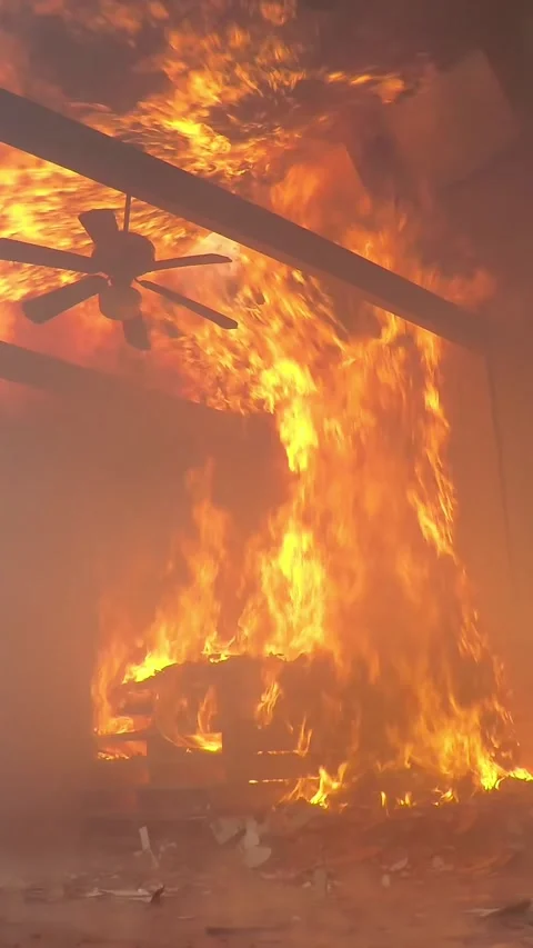 A dramatic fire has engulfed a large structure, showcasing the overwhelming Stock Footage 305278766