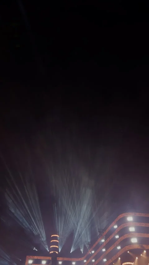 Dramatic fireworks display lighting night sky above modern stadium with glowing Stock Footage 342503652