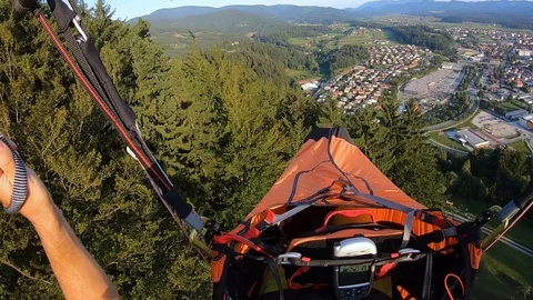 Dramatic first person perspective of a man paragliding dangerously low Stock Footage 119773839