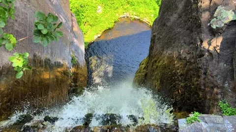 Dramatic First-Person View of Waterfall Cascading into Natural Pool Stock Footage 320879875