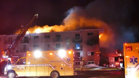 Dramatic flames during apartment building fire Stock Footage 105276804