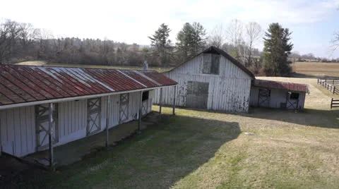Dramatic flight over barn to reveal pond Stock Footage 22948965