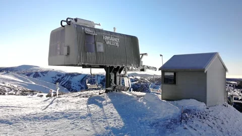 Dramatic Flight Over Ice Covered Ski Lift Station on Sunny Morning Stock Footage 137881100