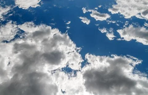 Dramatic Fluffy White Clouds in Deep Blue Sky Stock Photos