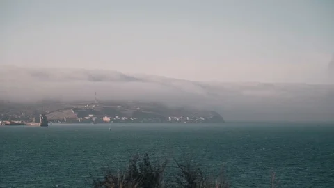 Dramatic fog goes down the mountain above the sea Stock Footage 127800030