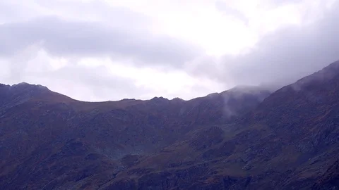 Dramatic fog over mountain timelapse Stock Footage 99430017