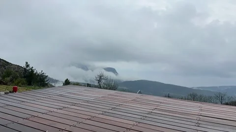 Dramatic fog rolling over mountains with moving clouds Stock Footage 334061004