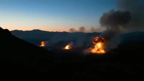 Dramatic Footage of a Bombardment in a Remote, Hilly Area. Stock Footage 315379064