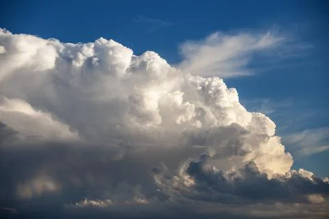 Dramatic formation of cumulus storm clouds against blue sky Stock Photos