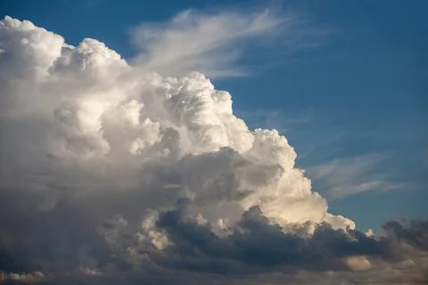 Dramatic formation of cumulus storm clouds against blue sky Stock Photos