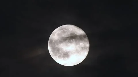Dramatic full moon rise through drifting dark clouds in 4k cinematic time lapse Stock Footage 305430238