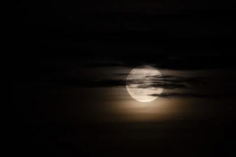 Dramatic Full Moon through clouds at Night Stock Photos
