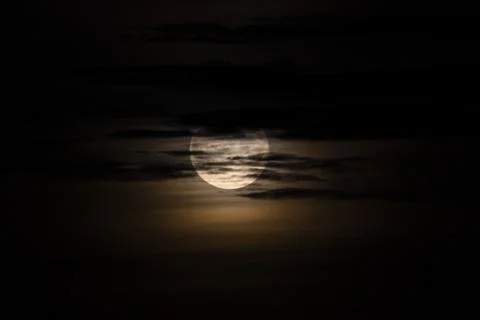 Dramatic Full Moon through clouds at Night 写真素材
