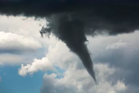 Dramatic funnel cloud created in dark storm clouds; Calgary, Alberta, Canada Stock Photos